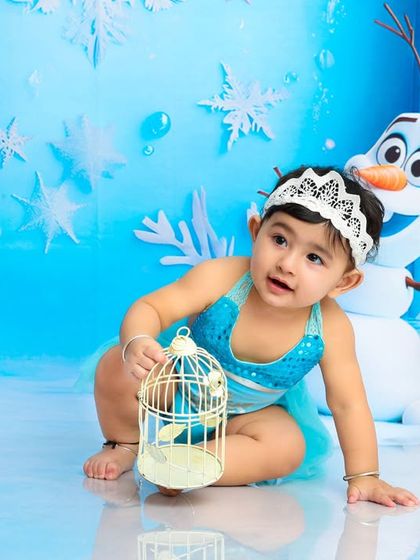 Exploring her ice palace with Olaf by her side. This photo captures a curious moment from our enchanting Frozen-themed photoshoot.