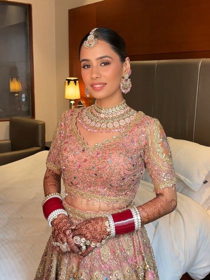 Harsheen's Anand Karaj look was breathtaking. Her intricately embroidered pastel lehenga was paired with a flawless base, soft pink eyeshadow, and a sleek bun adorned with a flower.