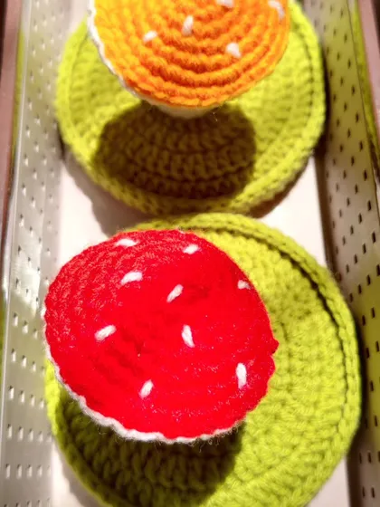 A top-down view of the red and yellow mushroom jewelry holders.