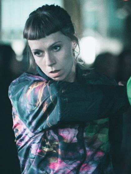 A close-up of a female dancer from the "To Da Bone" crew. Her focused expression conveys the intensity and dedication of the performers.