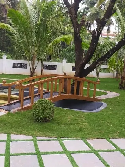 We integrate water features seamlessly into the surrounding landscape. This project included a large, free-form pond with a custom-built wooden bridge, connecting different parts of the garden and creating a beautiful focal point.