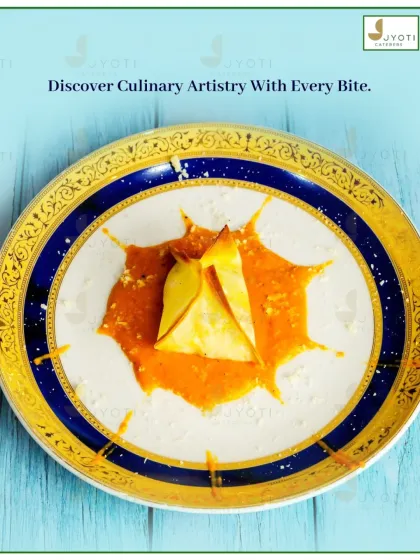 Discover culinary artistry with this elegantly plated appetizer. The delicate pasta parcel is served in a flavourful sauce, presented like a work of art on a fine china plate.