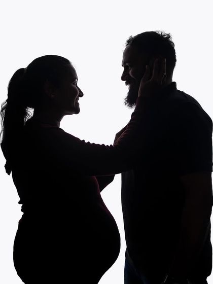 A playful and loving silhouette of a couple. The high-key lighting creates a clean and modern look, while their interaction keeps it personal and sweet.