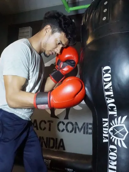 The heavy bag is where you build power. This student is working on his boxing technique, learning to put his whole body into each punch for maximum impact.