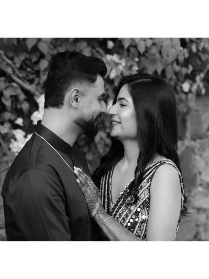A classic black and white portrait capturing a sweet, smiling glance between the couple. This timeless style emphasizes their emotion and connection without distraction.