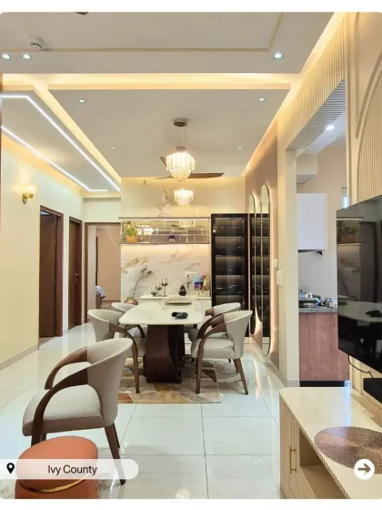 A long shot of a beautiful dining and living area, showing how I create a cohesive design flow between different functional zones in an open-plan home.