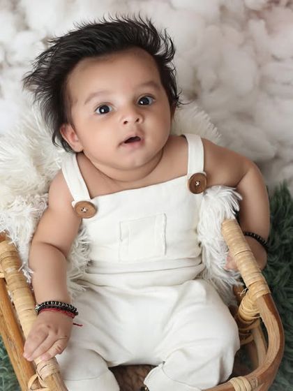 A sweet three-month-old boy looking up with an inquisitive expression. I use simple props like this basket and soft blankets to ensure the baby is comfortable and the portrait is timeless.