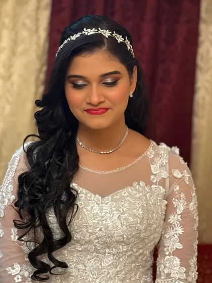 A close-up of the Christian bride's soft glam makeup, featuring shimmery eyes and a classic red lip.