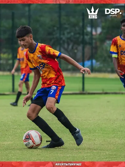 Dribbling through traffic. This player shows great composure and skill on the ball.