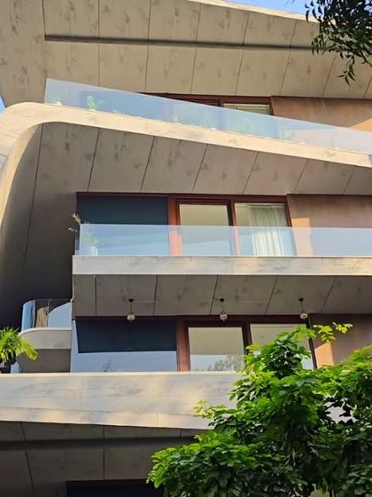 The fluid concrete forms of this residence are designed to feel organic and alive. Each level offers a different perspective, with cantilevered balconies that seem to float, creating a sense of lightness and movement.
