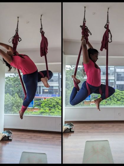 A student works on a deep backbend, using the hammock to safely open the shoulders and thoracic spine.