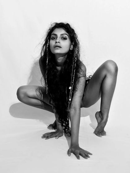 A raw and powerful black and white shot from a body-positive series. The pose is strong and unconventional.