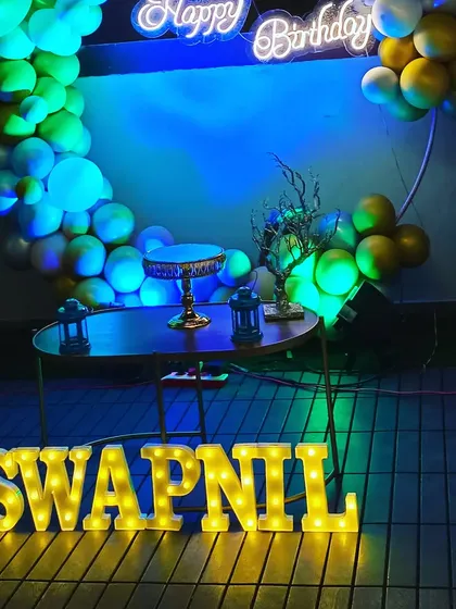 The full setup for Swapnil's surprise birthday, including the balloon ring, neon sign, and marquee letters. We ensure every element comes together for a cohesive and impressive display.