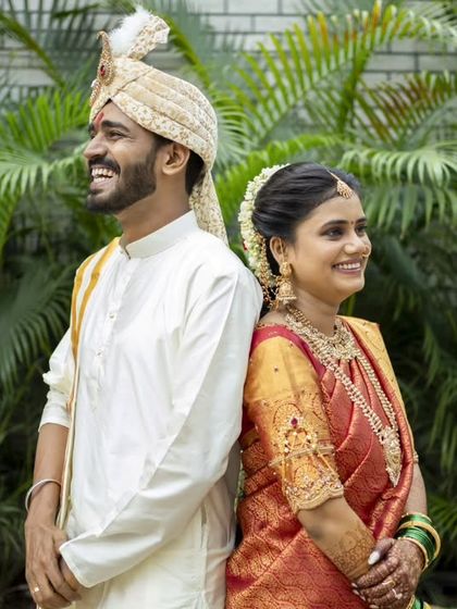 A stylish back-to-back pose, capturing the couple's happy and confident smiles.