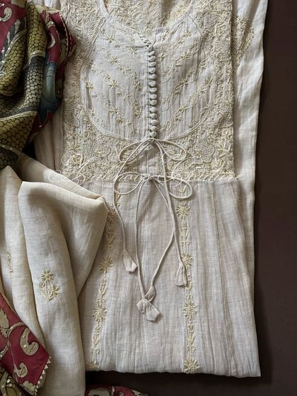 A straight-on view of the Anarkali's bodice, showing the symmetrical embroidery and the elegant tie-up feature.