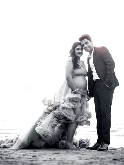 A timeless black and white version of a beach portrait, emphasizing the emotional connection and classic beauty of the moment.