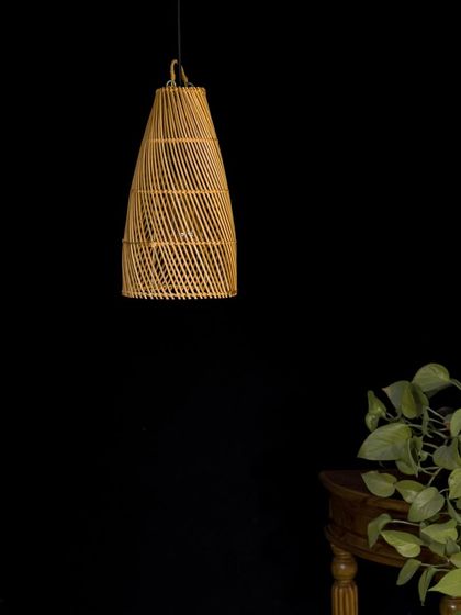 The same conical bamboo pendant, unlit. Notice the subtle variations in the bamboo and the neat finish at the top, details that speak to its artisanal origins.