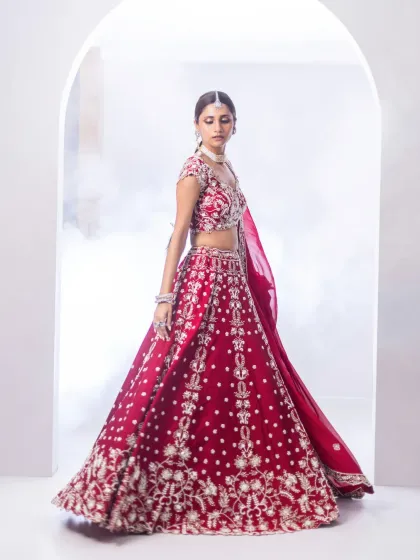 The movement and flow of this traditional red lehenga are captured perfectly here. The rich colour and detailed embroidery make it a bold and beautiful choice for the bride who wants to honour tradition with flair.