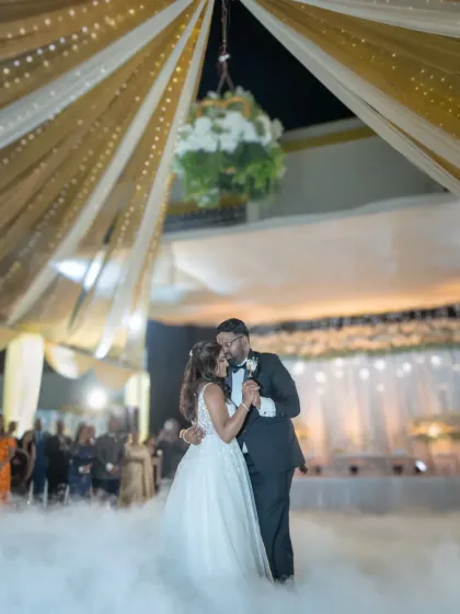 Dancing on a cloud. This beautiful first dance photo captures the romance and magic of the wedding reception, with dreamy smoke and elegant decor.