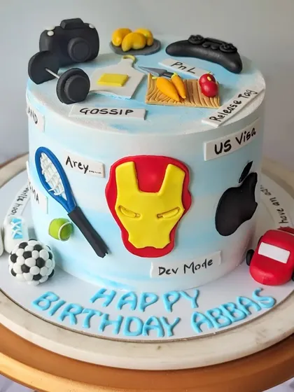 A second angle of the colleague's cake, this side features an Iron Man mask, the Apple logo, and a gaming controller. I can incorporate any number of hobbies and interests to make a cake uniquely personal.