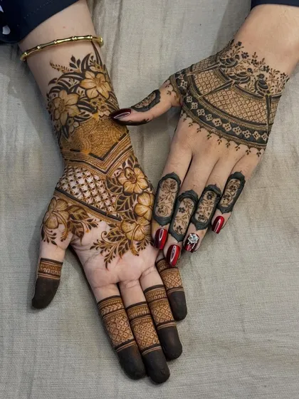 A showcase of two different but complementary styles. One hand features a dense floral and geometric pattern, while the other has a more traditional 'mandala' and 'jaal' design.