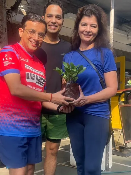 A member receiving a plant as a token of appreciation. We believe in promoting a green and healthy lifestyle.