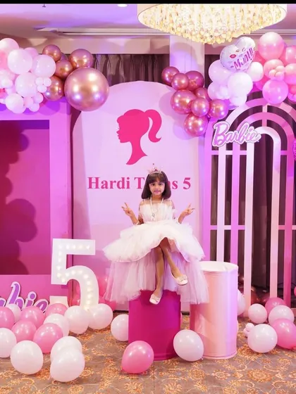 A dream come true for a little princess. This Barbie-themed 5th birthday party features a beautiful pink and white color palette, custom backdrops with the iconic Barbie silhouette, marquee lights, and elegant balloon garlands to make the birthday girl feel like royalty.