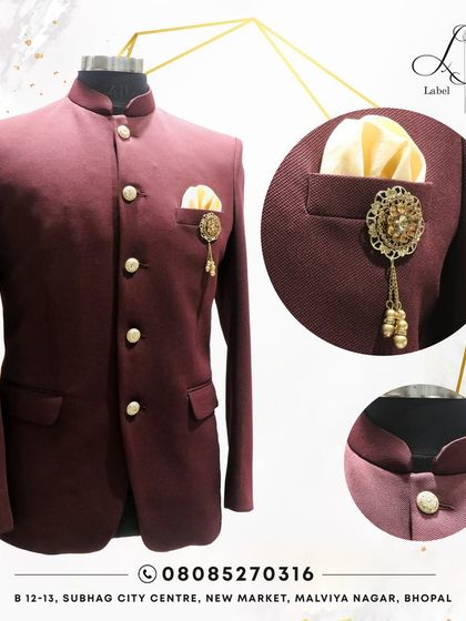 This rich maroon Jodhpuri suit is a classic choice for any celebration. The image highlights the sharp cut, the elegant buttons, and the custom brooch, showing how every detail is considered.