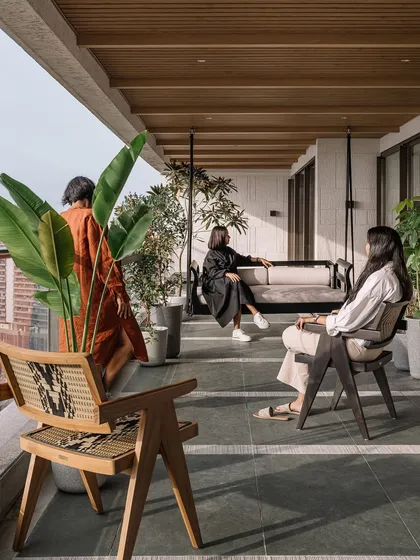 The expansive twenty-one-foot-long deck is the heart of the home. With a water feature, a custom swing, and plenty of greenery, it's a true sanctuary in the sky, perfect for watching the Mumbai sunset.