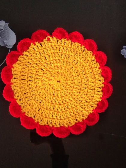 A round table mat in yellow and red.