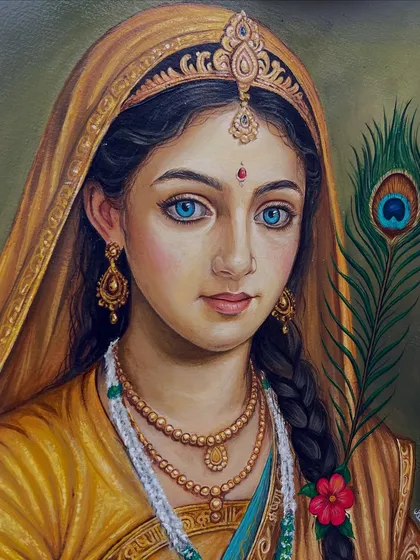 A close-up view of the Radha portrait, showing the fine brushwork on her expressive, bright blue eyes and traditional attire.