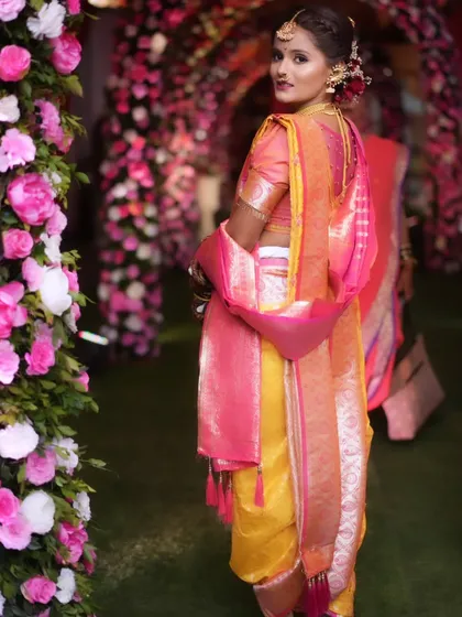 A beautiful back shot of the bride, showing off her intricate hairstyle and the elegant drape of her saree.