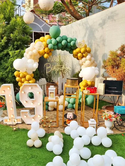 Another perspective of the rustic 19th birthday setup. This view shows how the balloon arch frames the space, with the marquee numbers and decor elements arranged for great photos in the daytime.