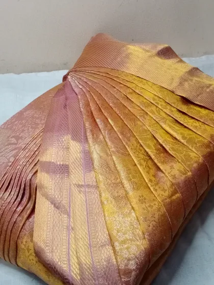 This lustrous gold and mauve saree is another example of my work. The pleats are done according to your measurements for a custom fit.