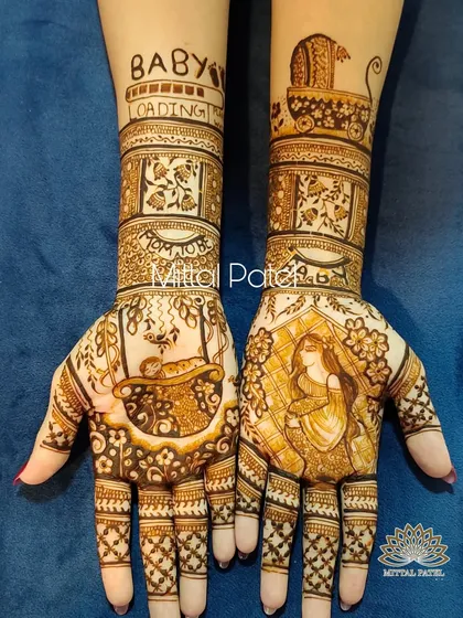 This pregnancy henna design is filled with anticipation. It features a portrait of the mother to be, a baby in a bassinet, and the phrase "Baby Loading" with a progress bar on the forearm.