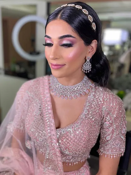 A close-up of this soft glam engagement makeup. The pink-toned eyeshadow with a hint of shimmer makes her eyes pop, while the diamond jewelry and headband add a touch of sparkle.