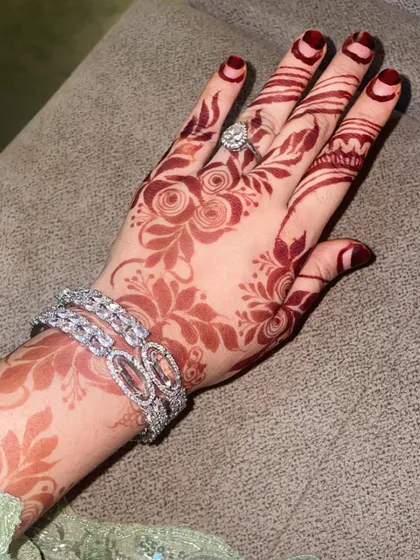 A fully developed henna stain after a few days. The color has deepened to a rich maroon, which looks stunning with jewelry. This is the long-lasting color you can expect.