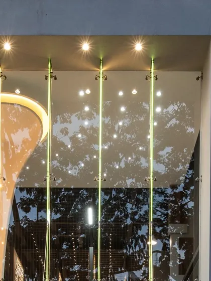 A detail of the facade lighting on the Aaren Intpro showroom, showcasing the clean lines and reflective qualities of the glass.