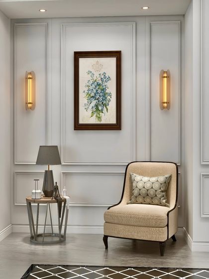 A duplicate of image 18, this intimate space is designed as a quiet retreat. The classic armchair, framed by elegant wall moldings and soft lighting from the sconces and table lamp, creates a perfect haven for reading and reflection.