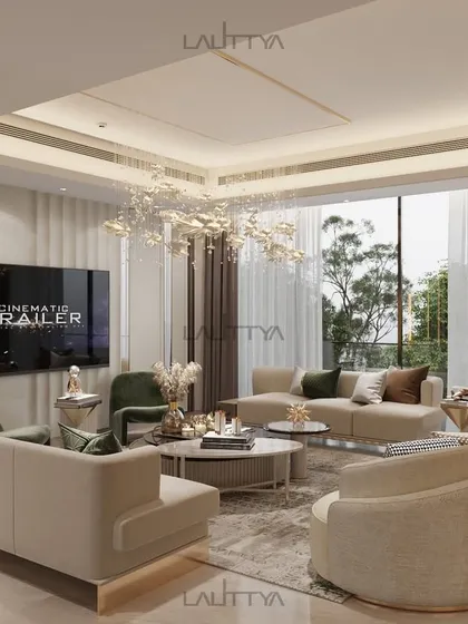 Natural light fills this living room, showcasing the soft forms of the custom sofas and armchairs. The open-plan design connects the space to the outdoors, creating an airy and expansive feel.