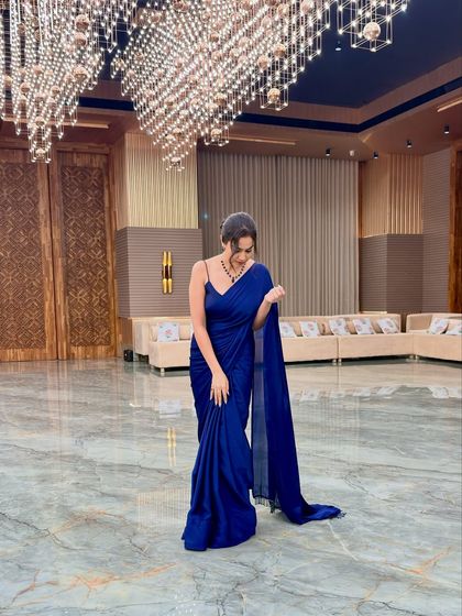 A candid moment, adjusting my saree before heading back to the stage.