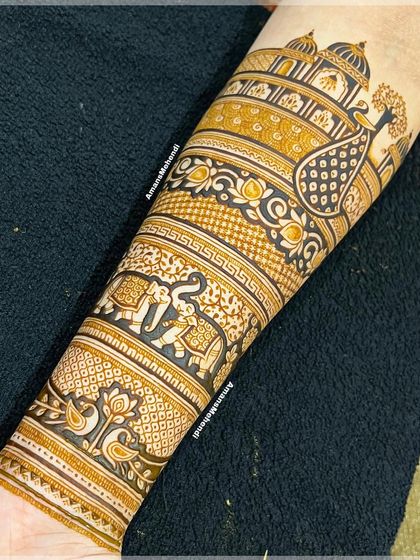 A full view of a completed bridal arm design. It features a procession of elephants, a majestic peacock, and a grand palace, all woven together with intricate patterns.