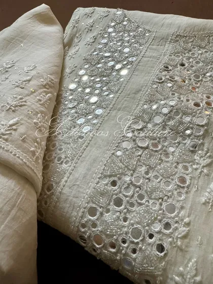 A close-up of the yoke, where mirrorwork is intricately placed within the Chikankari patterns, creating a stunning visual effect.