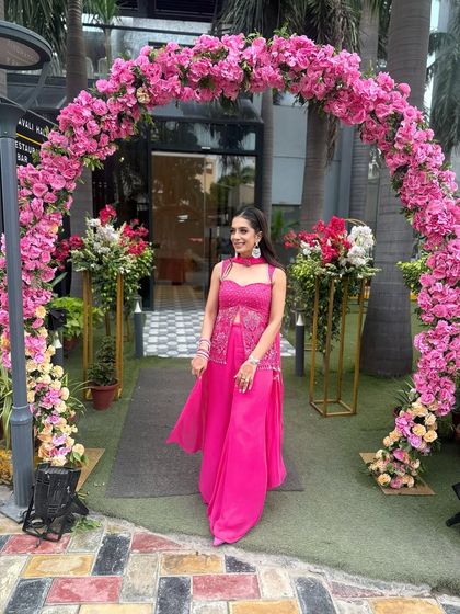 Posing under a beautiful floral arch. The vibrant pink of my outfit and the flowers created a perfect photo opportunity.