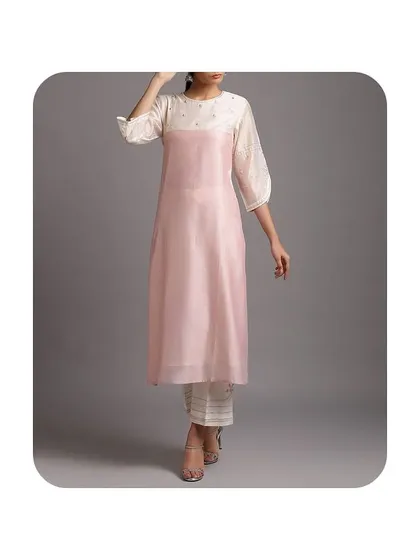 I can also work with modern, layered designs. This kurti features a sheer pink organza layer over a solid white inner piece, creating a contemporary and stylish silhouette.