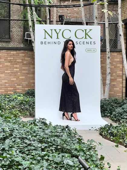 A behind-the-scenes snap at the NYC Calvin Klein event. It's not all glamour; there's a lot of setting up and waiting around to get the perfect shot against the official backdrop.