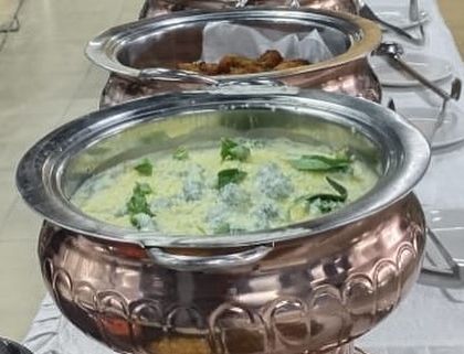 This creamy vegetable curry, garnished with fresh herbs, is a perfect example of our rich and flavorful vegetarian offerings, ideal for any buffet.