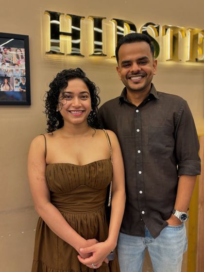A happy couple at the salon, with the lady showing off her gorgeous, newly styled curls.