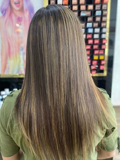 A beautiful result of highlights on straight hair, adding depth and a touch of brightness to the client's natural color.