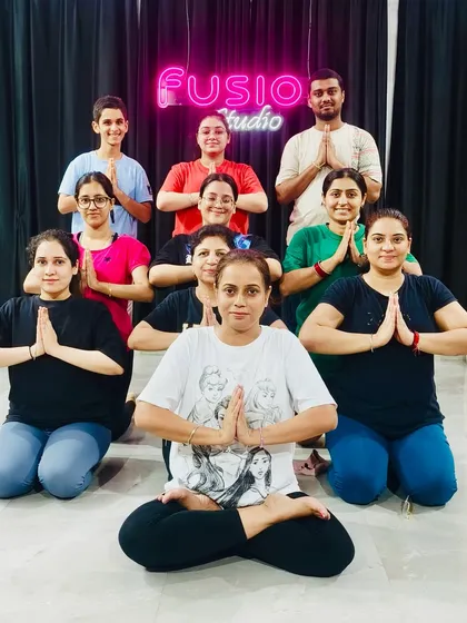 The Fusion fam post-yoga session! We love to have fun and connect after class. Here we are striking a Namaskar pose together.